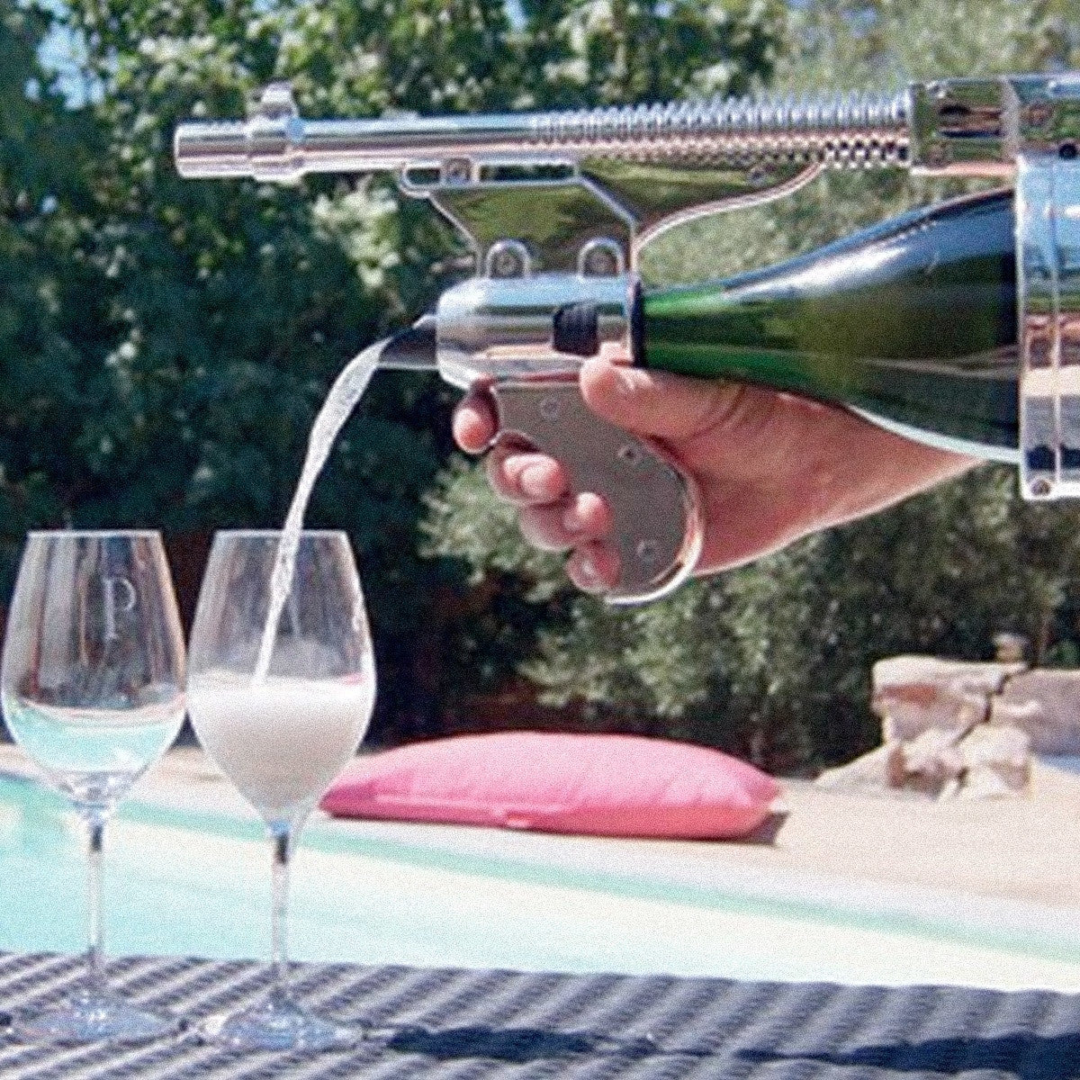 someone pouring champagne from a champagne gun